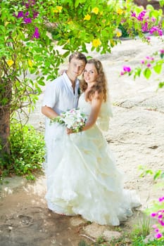 Bride and groom in a tropical garden