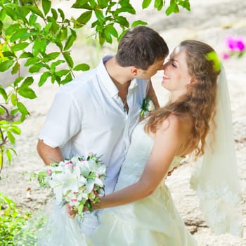 Bride and groom in a tropical garden