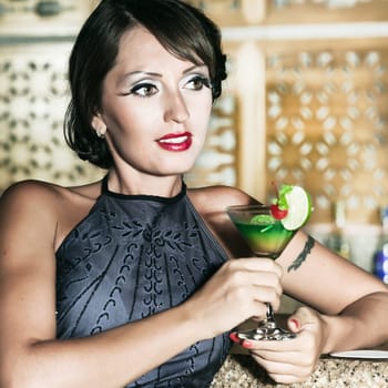 Fashion woman retro portrait with a cocktail