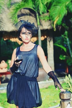 Fashion woman portrait with glass of wine outdoor