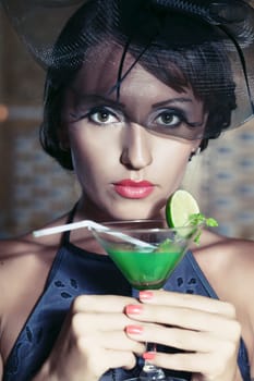 Fashion woman retro portrait with a cocktail