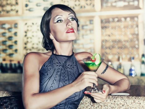 Fashion woman retro portrait with a cocktail