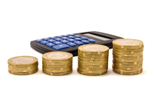 economy concept. calculator and stacks of coins over white