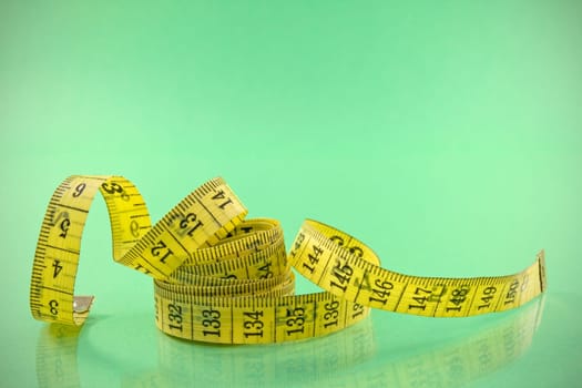 yellow  measure tape  on the green background