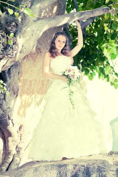 Beautiful bride under the tree. Tropical wedding