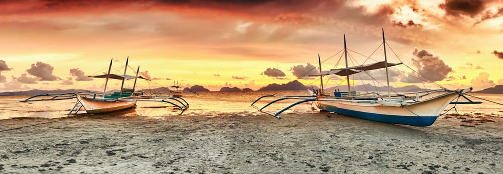 Traditional philippine boats bangka at sunset time