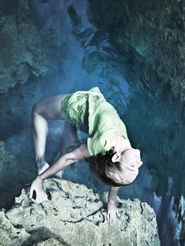 Woman like mermaid in wet dress in lake