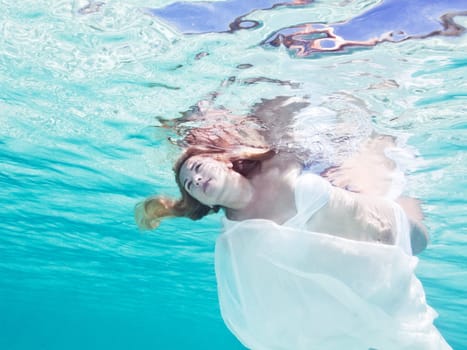 Fashion beautiful woman underwater like a mermaid