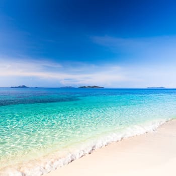 Tropical sandy beach Malcapuya at summer sunny day