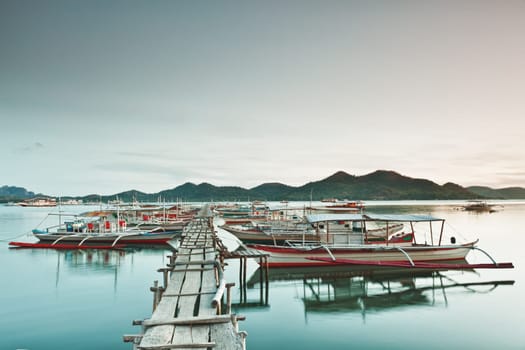 Wooden pier and bahgka boats in Coron