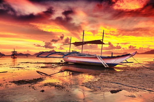 Traditional philippine boat bangka at sunset time