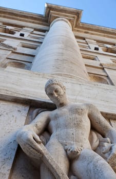 Man statue of the exchange building of Milan, Italy