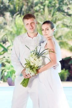 Bride and groom near the swimming pool