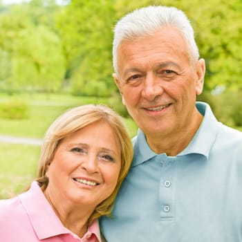 Portrait of romantic senior couple outdoors.