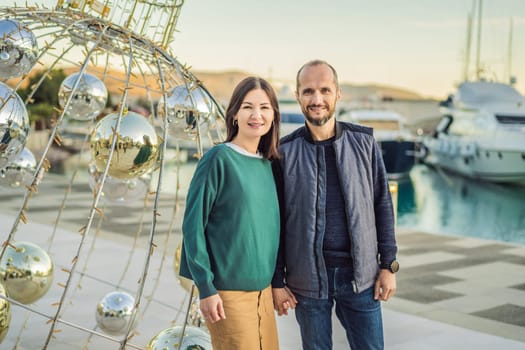 Couple in love tourists enjoying the views of Architecture and luxury yachts in Lustica Bay, Montenegro. Travel around Montenegro concept. Go Everywhere.