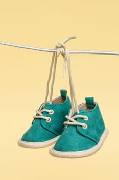 The delicate sight of baby shoes hanging from a clothesline evokes emotions of anticipation and joy