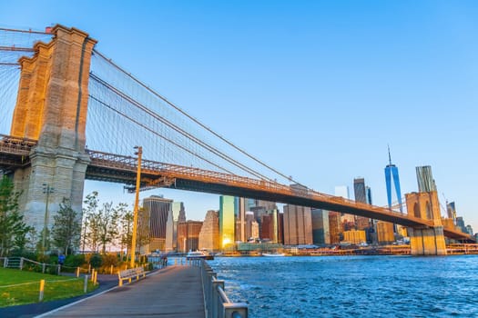 Manhattan's skyline with Brooklyn bridge, cityscape of New York City in the United States of America at sunrise