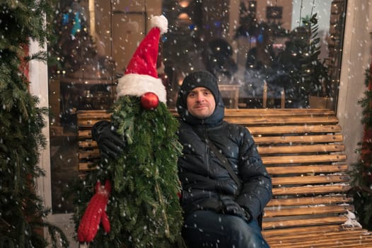 Man with fir tree decorated mannequin. Xmas holidays, New Year or Christmas concept