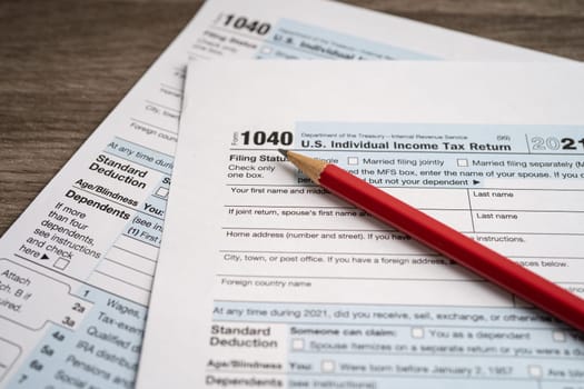 Tax Return form 1040 with pencil, U.S. Individual Income.