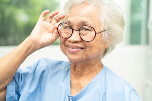 Asian senior woman wearing eyeglasses or vision glasses at home care service.