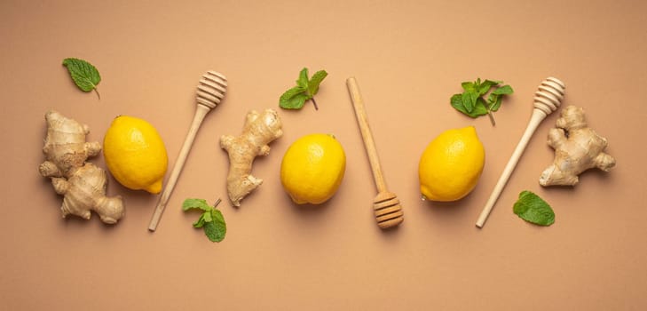 Composition with lemons, mint, ginger top view on simple beige background. Food for immunity stimulation and against seasonal flu. Healthy natural remedies to boost immune system.