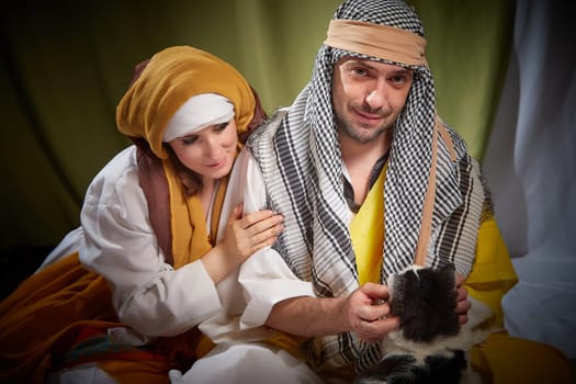 A couple in love or a married couple in stylized Eastern clothing from Israel, Palestine, Iran, Pakistan together. Tender photo session in the style of the Middle East and the Bible