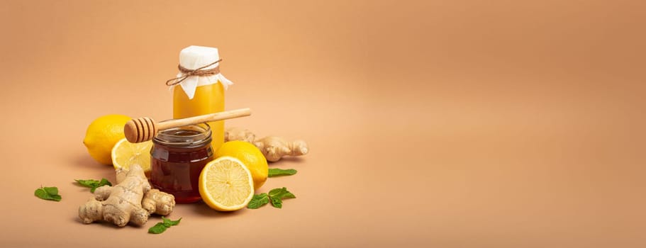 Composition with detox drink, sea buckthorn berries, lemons, mint, ginger, honey in glass jar. Food for immunity stimulation and against flu. Healthy natural remedies to boost immune system.