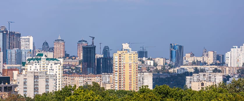 Aerial photography of residential areas of Kyiv with a view of the railway station and new skyscrapers under construction, aerial view, city photography. Copy space.