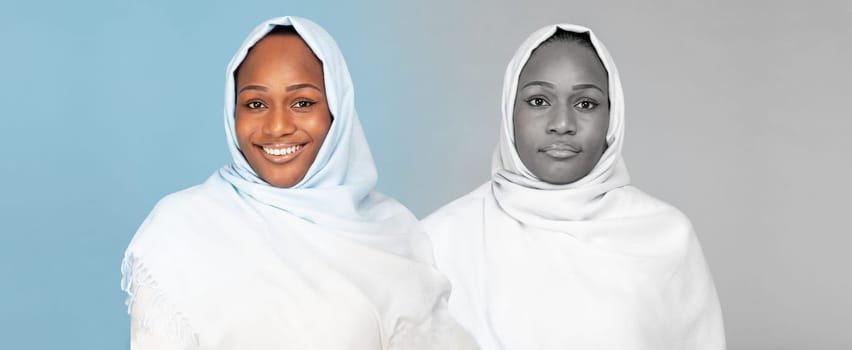 Smiling, unhappy millennial arab woman in hijab suffer from depression on blue and gray background, panorama, studio. Mental problems, negative emotions, lifestyle and stress
