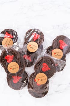 Chocolate cookies with chocolate hearts for Valentine's Day packaged in plastic gift bags.