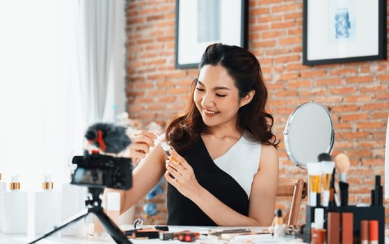 Woman influencer shoot live streaming vlog video review makeup uttermost social media or blog. Happy young girl with cosmetics studio lighting for marketing recording session broadcasting online.