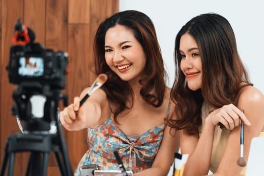 Woman influencer shoot live streaming vlog video review makeup uttermost social media or blog. Happy young girl with cosmetics studio lighting for marketing recording session broadcasting online.