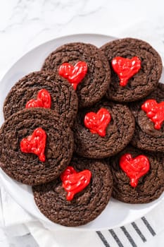 Freshly baked chocolate cookies with chocolate hearts for Valentine's Day.