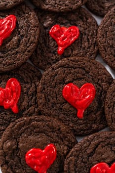 Freshly baked chocolate cookies with chocolate hearts for Valentine's Day.