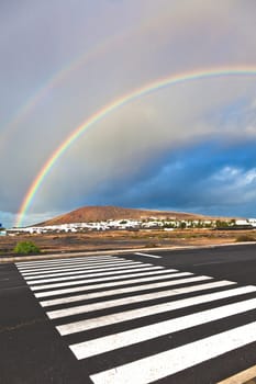 beautiful rainbow over the mountain with dark clouds