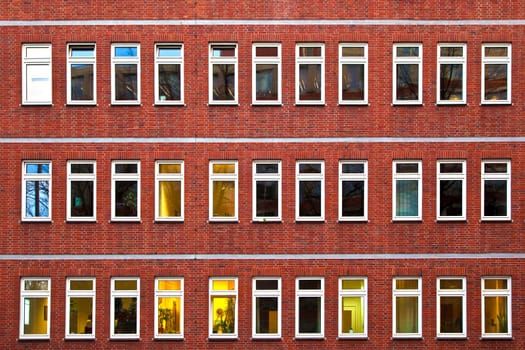 facade of office building in the evening with illuminated windows