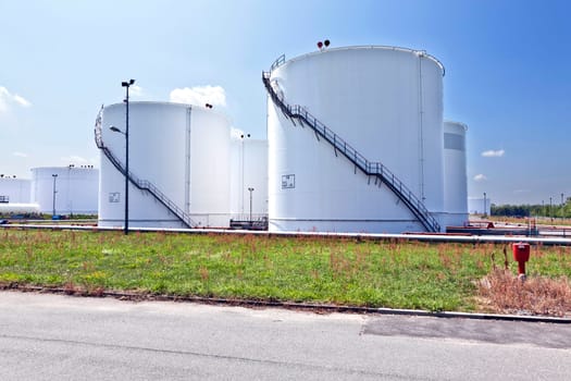 Big white industrial tank with blue sky