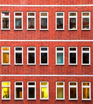 facade of office building in the evening with illuminated windows