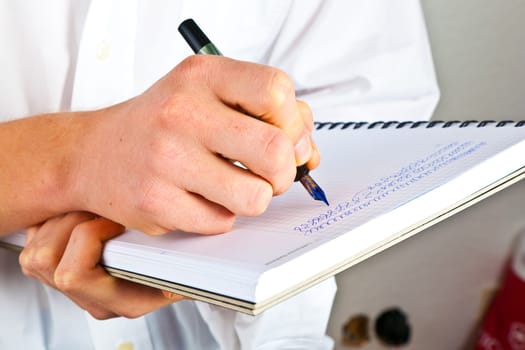 man writing in a book