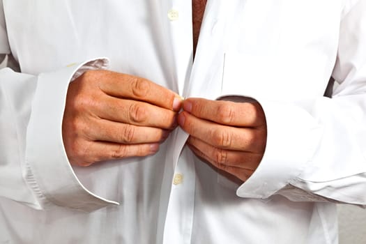 man closing his shirt