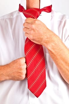 attractive man binding his tie