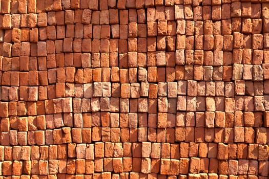 red stapled bricks give a harmonic pattern in the sun