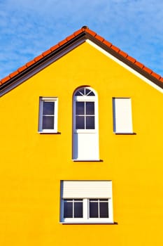generic family home in suburban area with blue sky