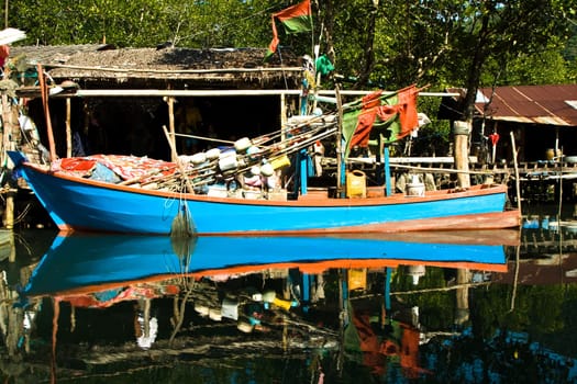 huts and colorful  fisherboats at the mangrove everglades in a small fishermans village in Koh Chang
