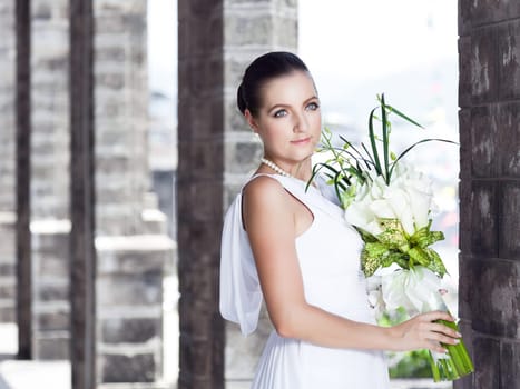 Beautiful bride with a wedding bouquet outdoor