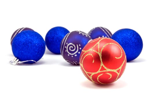 red christmas bauble in a front of blue ones