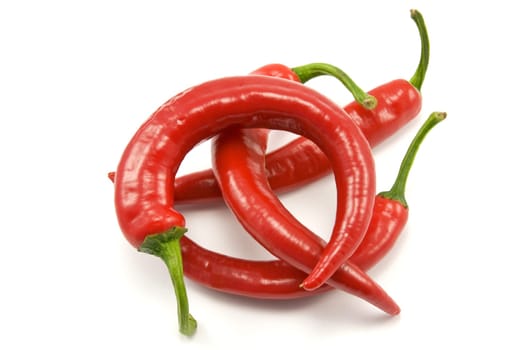 pile of chili peppers over a white background