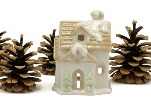christmas house and pine cones isolated on white