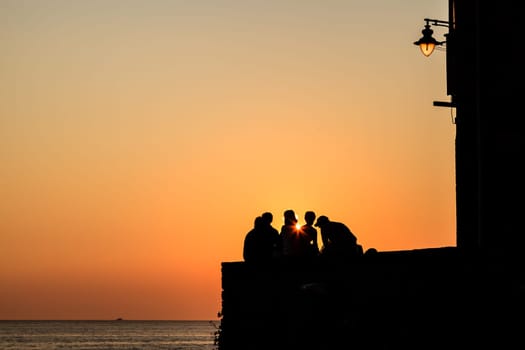 Group of People Watching Sunset in Riomaggiore, Italy