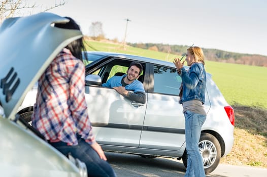 Car troubles two woman friends asking help young man